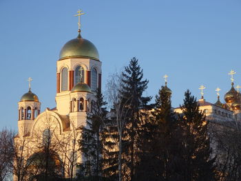 Low angle view of building and trees against sky