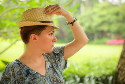 Portrait of young woman looking away outdoors