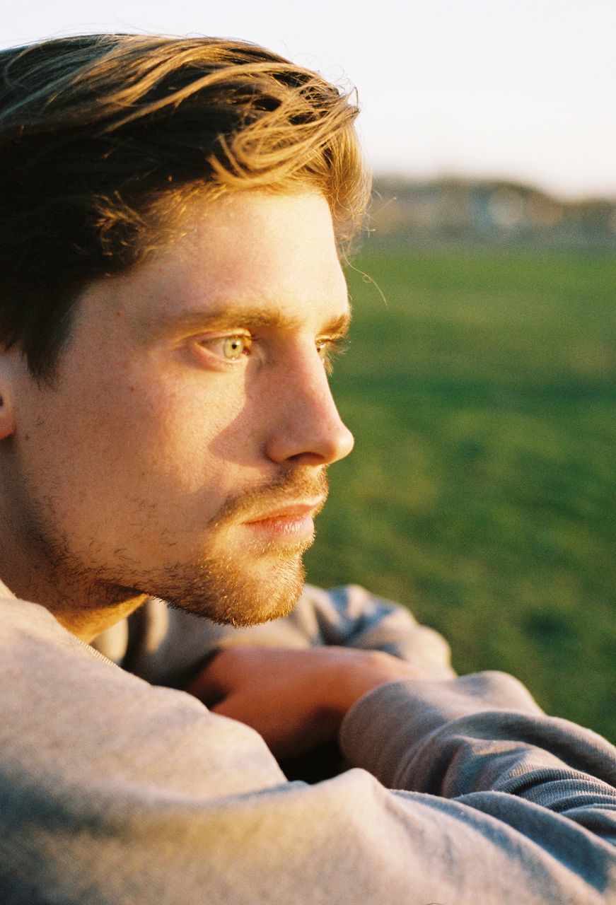 young adult, headshot, one person, one young man only, young men, only men, outdoors, one man only, adult, adults only, people, portrait, day, day dreaming, close-up, men, sky, macho