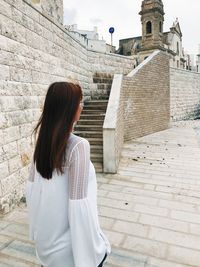 Midsection of woman standing at historic building