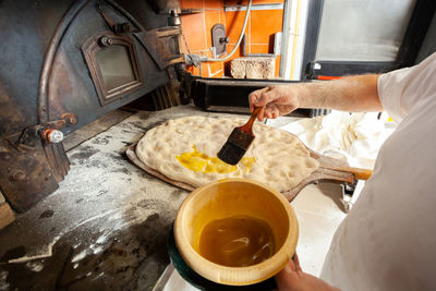 Production of baked bread with a wood oven in a bakery.