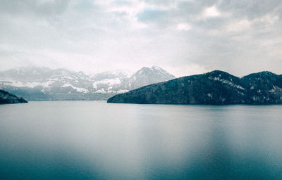 Scenic view of lake and mountains against sky