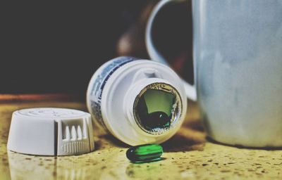 Close-up of container with capsules on table