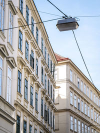 Low angle view of buildings against blue sky