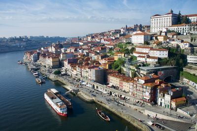 High angle view of buildings by sea against sky