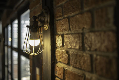 Close-up of light bulb against wall