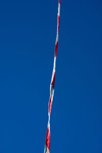 Low angle view of rope against clear blue sky