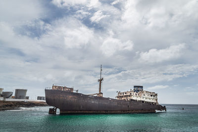 Abandoned boat in the sea. cloudy sky with copy space.