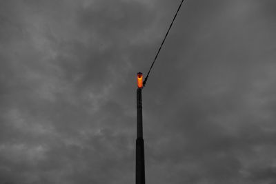 Low angle view of street light against sky