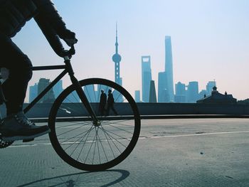 Man with bicycle in city