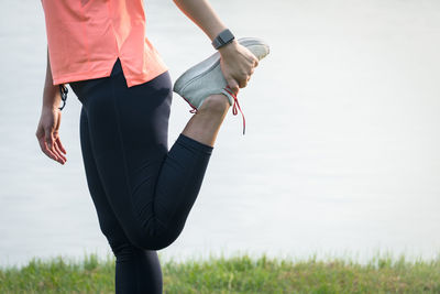 Midsection of woman standing on field