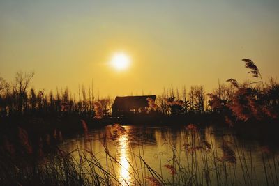 Scenic view of lake at sunset