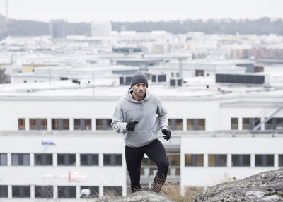 Man jogging against buildings