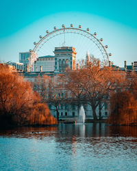 A view of the london eye behinds the horse guards parade from st. james's park