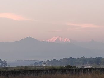 Scenic view of field against sky during sunset