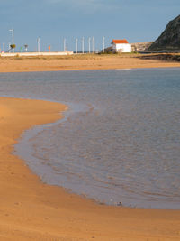 Scenic view of beach against sky during sunny day