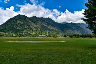 Scenic view of landscape and mountains against sky