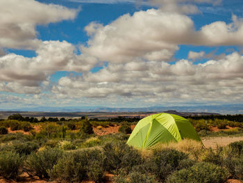 Scenic view of field against cloudy sky