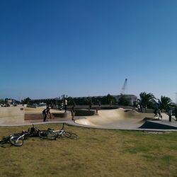 People on runway against clear sky