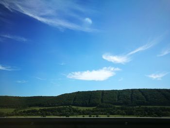 Scenic view of landscape against blue sky