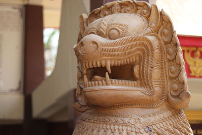 A stone lion statue on blur background