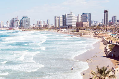 Panoramic shot of sea and buildings against sky