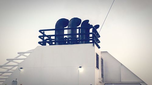 Low angle view of silhouette building against sky