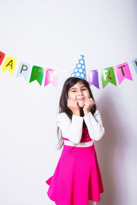 Portrait of happy woman standing against multi colored background
