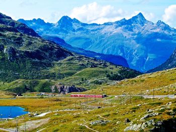 Scenic view of mountains against blue sky