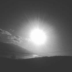 Sun shining over calm lake