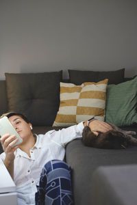 Young woman sleeping on sofa at home