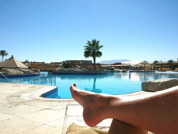 Swimming pool against clear blue sky