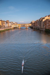 Bridge over river with city in background