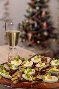 Toasted bread with sprats, eggs and herbs. traditional russian food for the new year's table.