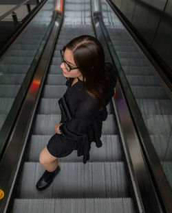 High angle view of woman on escalator