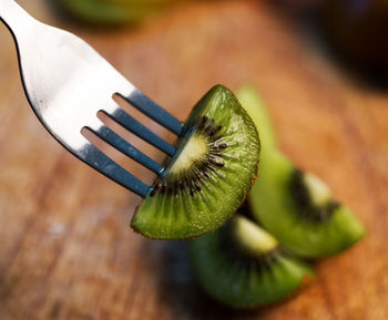 Close-up of kiwi slice on fork