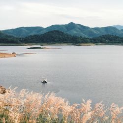 Scenic view of lake and mountains against sky
