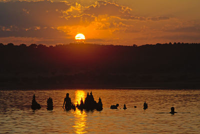 Silhouette woman swimming in lake