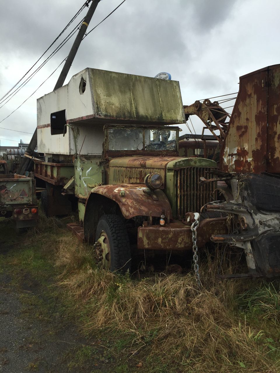 architecture, built structure, building exterior, sky, old, cloud - sky, abandoned, transportation, run-down, obsolete, deterioration, damaged, cloudy, low angle view, history, outdoors, building, mode of transport, house, land vehicle