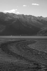 Scenic view of land and mountains against sky