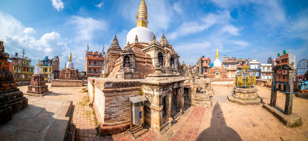 Panoramic view of buildings in city against sky