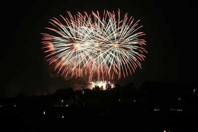 Low angle view of firework display at night