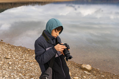 Young man photographing with camera