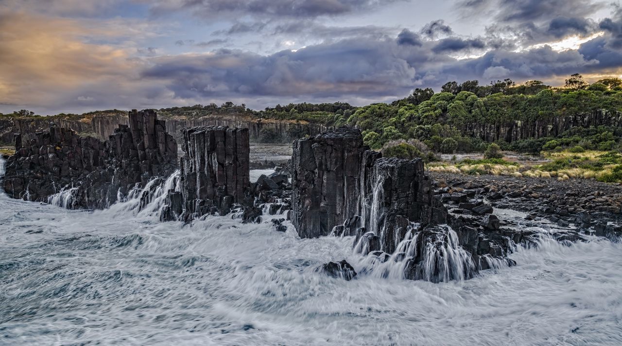 SCENIC VIEW OF ROCKS ON SEA AGAINST SKY