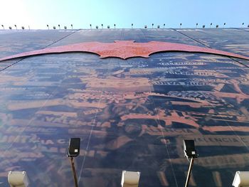 Birds flying over landscape against sky