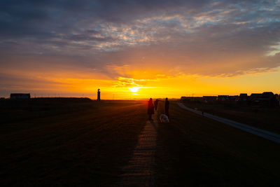 Scenic view of field against sky during sunset