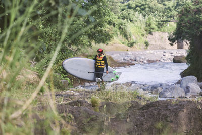 Man with stand up puddle surfboard