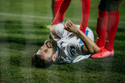 Low section of man lying on grass