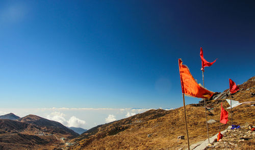 Panoramic view of landscape and mountains against blue sky