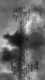 Low angle view of crane against cloudy sky